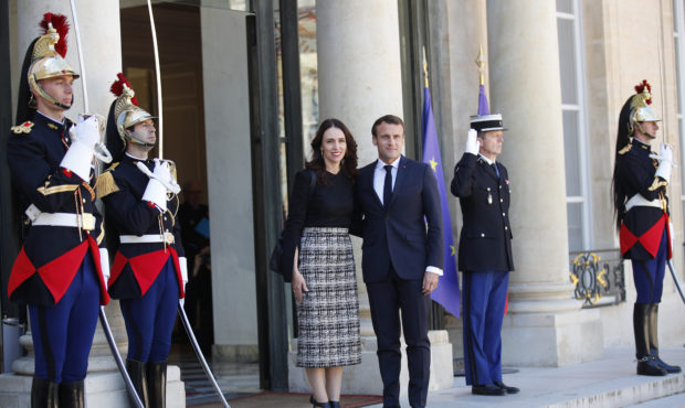 New Zealand Prime Minister Jacinda Ardern, center left, is greeted by French President Emmanuel Mac...