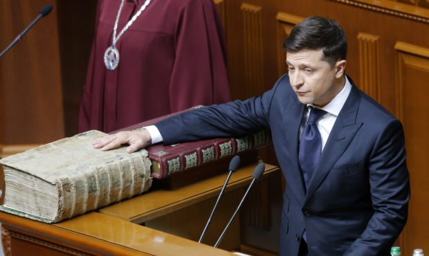 Ukrainian President-elect Volodymyr Zelenskiy swears on the Bible as he takes the oath of office du...