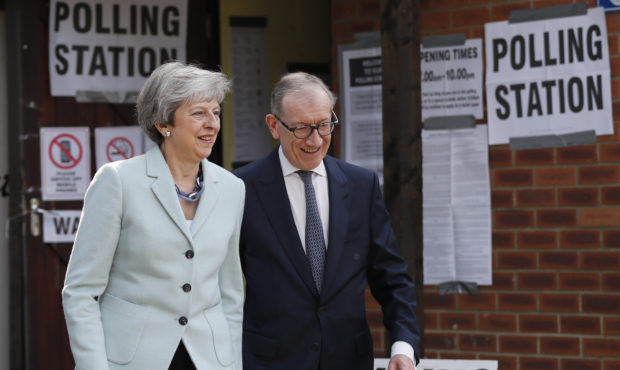 Britain's Prime Minister Theresa May and her husband Philip leave a polling station after voting in...