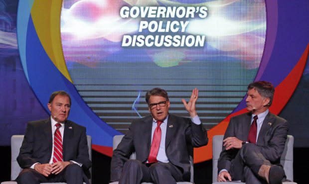 U.S. Energy Secretary Rick Perry, center, speaks as Utah Gov. Gary Herbert, left, and and Wyoming G...