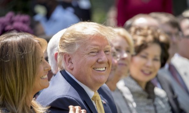 President Donald Trump and First lady Melania Trump, left, smile during a one year anniversary even...