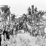 FILE - In this May 10, 1869, file photo, provided by the Union Pacific, railroad officials and employees celebrate the completion of the first railroad transcontinental link in Promontory, Utah. The Union Pacific's Locomotive No. 119, right, and Central Pacific's Jupiter edged forward over the golden spike that marked the joining of the nation by rail. (Andrew Russell/Union Pacific via AP, File)
