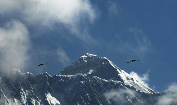 Birds fly as Mount Everest is seen from Namche Bajar, Solukhumbu district, Nepal, Monday, May 27, 2...