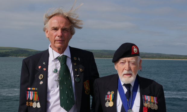 Former Royal Marine Les Budding, right, stands with Philip Collins, 62, who is the son of the late ...