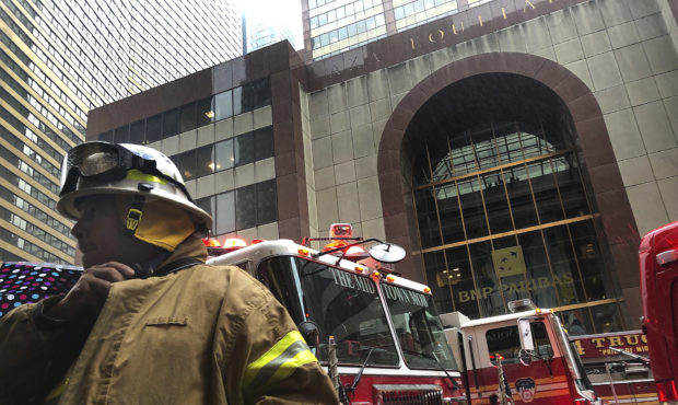A New York City firefighter responds to the scene where a helicopter crash-landed on the roof of a ...