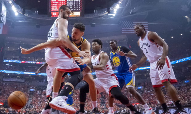 Golden State Warriors guard Klay Thompson (11) reaches for the ball past Toronto Raptors' Marc Gaso...