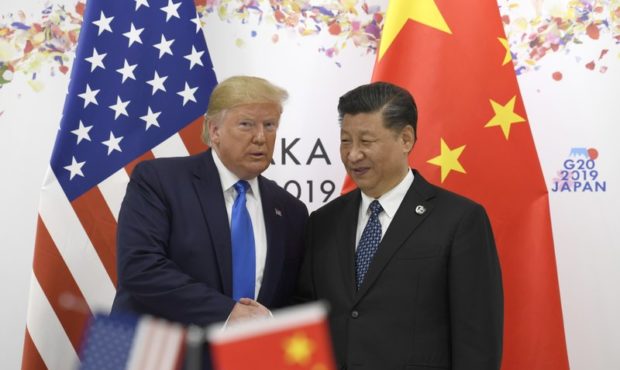 President Donald Trump poses for a photo with Chinese President Xi Jinping during a meeting on the ...
