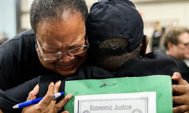 Marijoyce Campbell, a 65-year-old lifelong Flint resident, cries in the arms of a friend after spea...