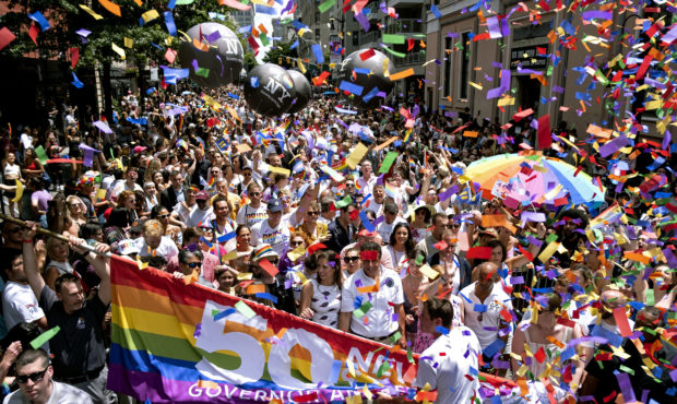 New York Governor Andrew Cuomo, lower front center, joins people participating in the LBGTQ Pride m...