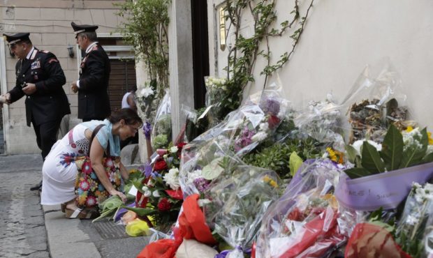 A woman leaves flowers in front of the Carabinieri station where Mario Cerciello Rega was based, in...