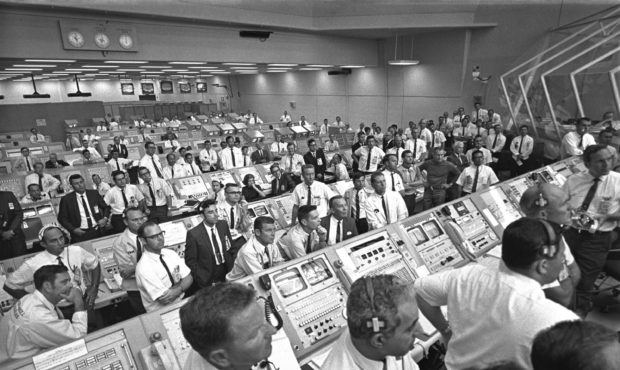 This July 1969 photo provided by NASA shows launch controllers in the firing room at the Kennedy Sp...