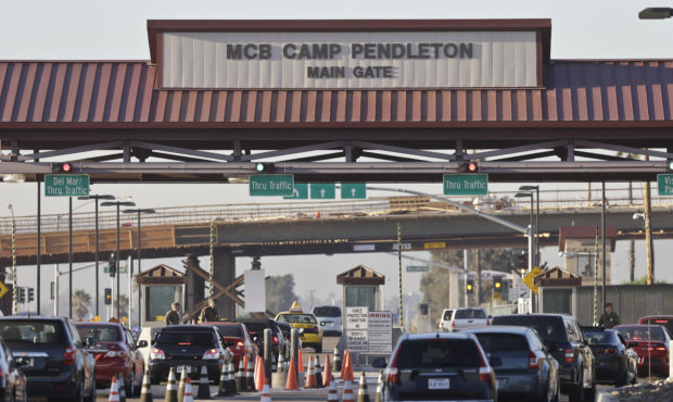 FILE - In this Nov. 13, 2013 file photo vehicles file through the main gate of Camp Pendleton Marin...
