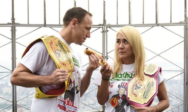 Eleven-time and defending men's champion Joey Chestnut, left, and defending women's champion Miki S...