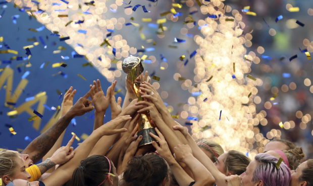 The United States players hold the trophy celebrating at the end of the Women's World Cup final soc...