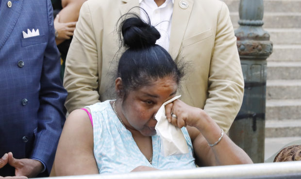 Esaw Snipes, widow of chokehold victim Eric Garner, wipes her eyes during a news conference outside...