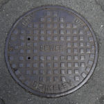 A cover for a sewer is shown in an intersection in Berkeley, Calif., Thursday, July 18, 2019. There are no manholes in Berkeley, as city workers will drop into "maintenance holes" instead. Nothing is manmade in the liberal city, it’s “human-made.” Berkeley leaders voted unanimously this week to replace about 40 gender-specific words in the city code with gender-neutral terms. (AP Photo/Jeff Chiu)