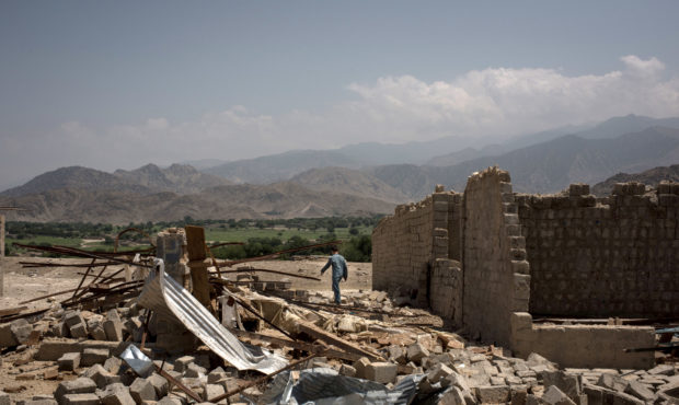 SHADAL BAZAAR, AFGHANISTAN - JULY 15: A boy walks through buildings damaged from fighting on July 1...