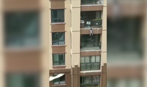 The 3-year-old boy was caught by a blanket, held by spectators below the building....