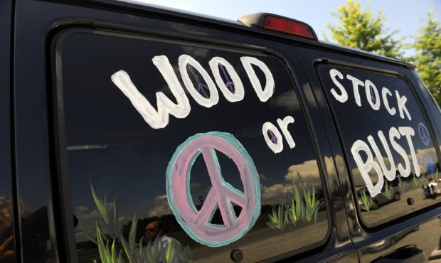 FILE - This Aug. 14, 2009 file photo shows a van decorated with "Woodstock or Bust" at the original...