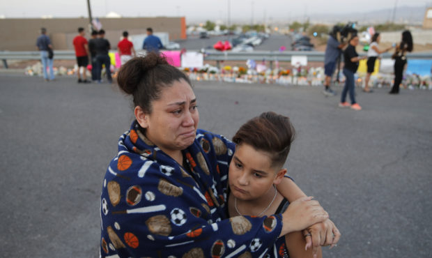 Clarissa Hernandez holds Ezra Magallanes as they speak with the media at a makeshift memorial for v...