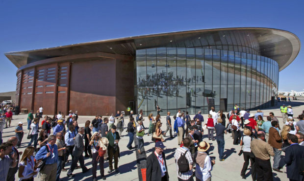 FILE - In this Oct. 17, 2011 file photo, guests stand outside the new Spaceport America hangar in U...