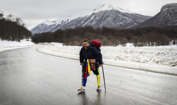Venezuelan Yeslie Aranda, 57, walks on Route 3 between Tolhuin and Ushuaia, Argentina, Saturday, Au...