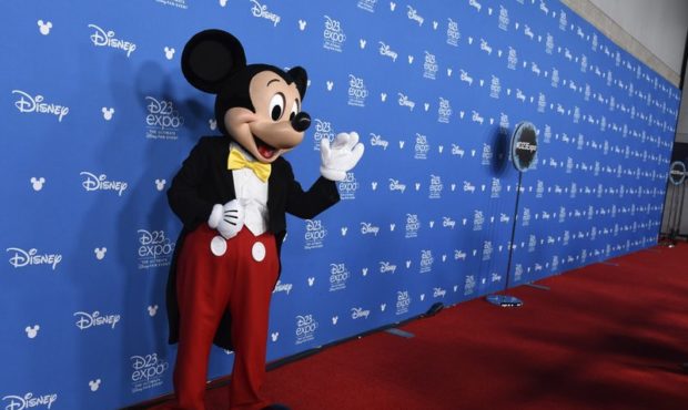 ILE - In this Aug. 8, 2017, file photo, The Walt Disney Co. logo appears on a screen above the floo...