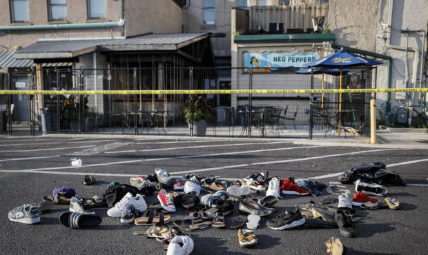 Shoes are piled outside the scene of a mass shooting including Ned Peppers bar, Sunday, Aug. 4, 201...