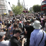 The road is blocked and the crossing obscured as thousands of fans gather to walk across the Abbey Road zebra crossing on the 50th anniversary of British pop musicians The Beatles doing it for their album cover of 'Abbey Road' in St Johns Wood in London, Thursday, Aug. 8, 2019. They aimed to cross 50 years to the minute since the 'Fab Four' were photographed for the album. (AP Photo/Kirsty Wigglesworth)