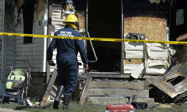 Erie Bureau of Fire Inspector Mark Polanski helps investigate a fatal fire at 1248 West 11th St. in...