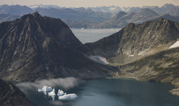 In this photo taken on Wednesday, Aug. 14, 2019, icebergs are photographed from the window of an ai...