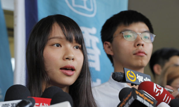 Pro-democracy activists Joshua Wong, right, and Agnes Chow speak to media outside a district court ...