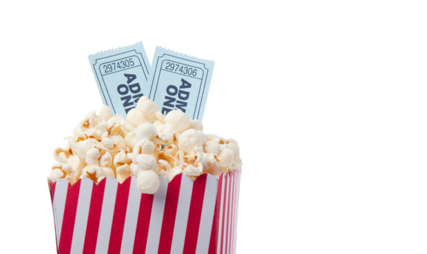 Red Striped Popcorn Bag And Movie Ticket On White Background For Cinema Concept.Two blue theatre ti...