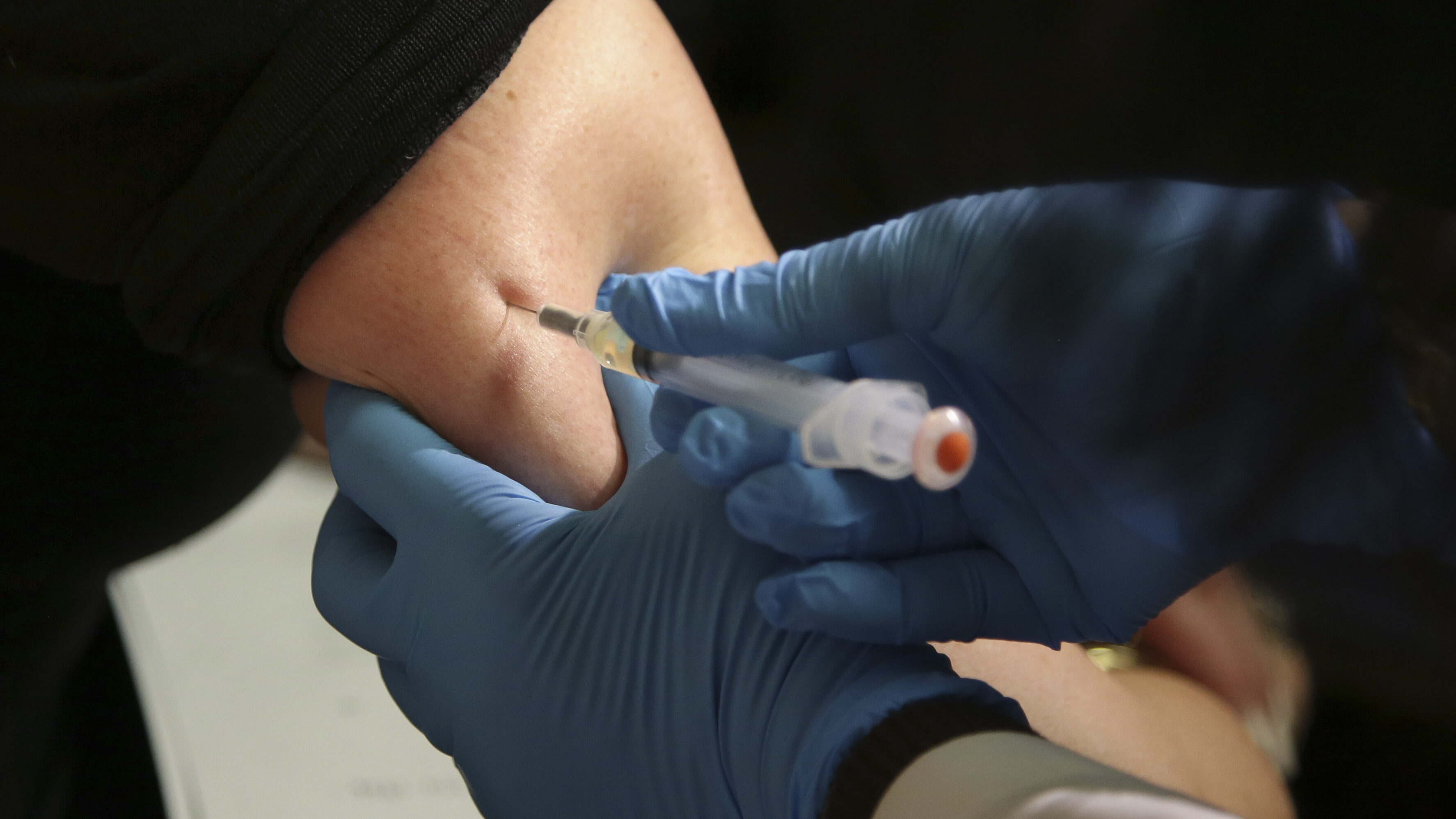 Image shows a person receiving a measles vaccine, Based on national behavior, measles cases are lik...