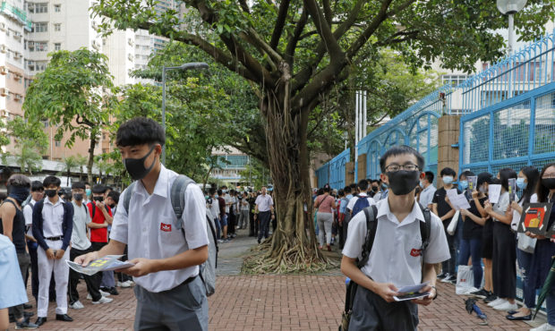 High school students wearing masks, deliver leaflets to support the school boycott, in Hong Kong, W...
