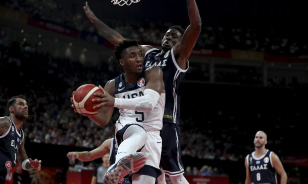 United States' Donovan Mitchell keeps the ball from Greece's Thanasis Antetokounmpo during phase tw...