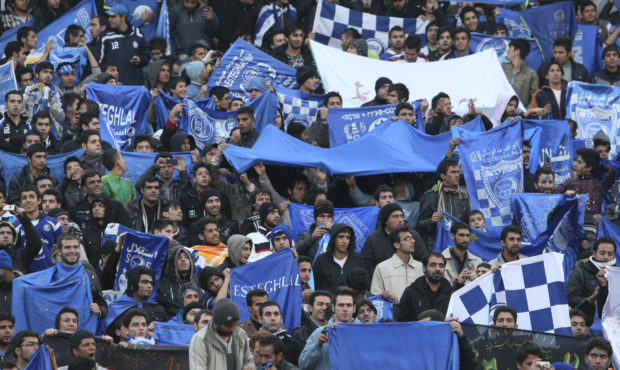 FILE  - In this Dec. 9, 2011 file photo, supporters of Iranian soccer team Esteghlal, hold flags of...
