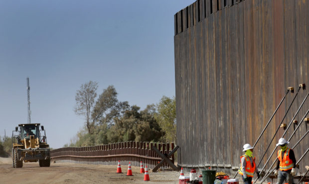 Government contractors erect a section of Pentagon-funded border wall along the Colorado River. (AP...