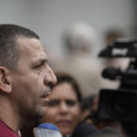 Daniel Freitas, talks to journalists about his mother, Irene Freitas, who died in the fire at the Badim Hospital, outside the the Medical Legal Institute morgue in Rio de Janeiro, Brazil, Friday, Sept. 13, 2019. The fire raced through the hospital in Rio de Janeiro, forcing staff to wheel patients into the streets on beds or in wheelchairs and leaving at least 11 people dead, Brazilian officials said Friday. (AP Photo/Leo Correa)