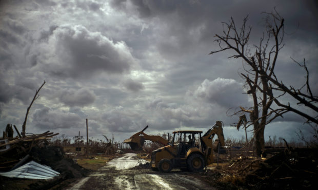 Mos Antenor, 42, drives a bulldozer while clearing the road after Hurricane Dorian Mclean's Town, G...