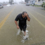 Angel Marshman wades through floodwaters from Tropical Depression Imelda after trying to start his flooded car Wednesday, Sept. 18, 2019, in Galveston, Texas. (AP Photo/David J. Phillip)