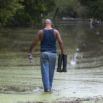 Gabino Hernandez walks down a flooded section of West Nasa Road in Webster, Texas on Wednesday, Sept. 18, 2019. Floodwaters from Clear Creek inundated the area from Tropical Depression Imelda. (Stuart Villanueva/The Galveston County Daily News via AP)