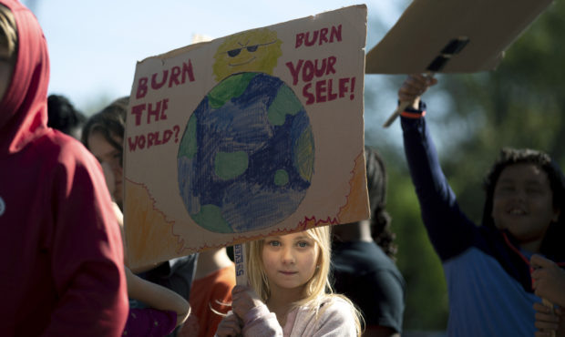 A student holds a sign while participating in a "Global Climate Strike" at the Experiential School ...