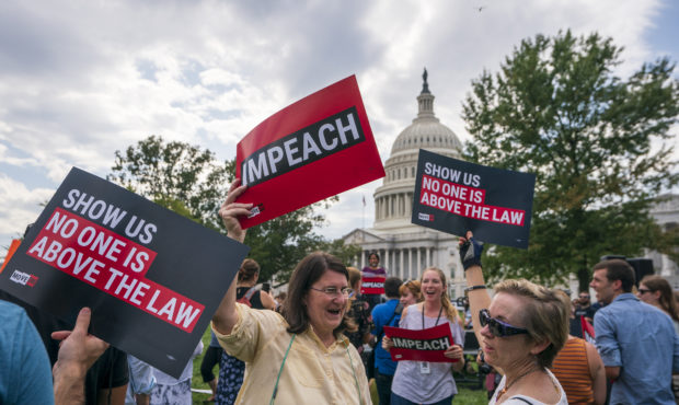 Activists rally for the impeachment of President Donald Trump, at the Capitol in Washington, Thursd...