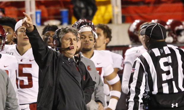 Washington State head coach Mike Leach speaks with a official in the first half of an NCAA college ...