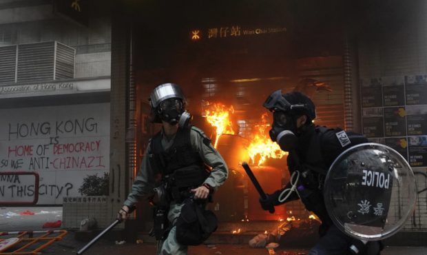 Riot police arrive after protestors vandalize in Hong Kong, Sunday, Sept. 29, 2019. Riot police fir...