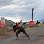 A visitor from California posing in front of the back gate of Area 51 on September 19, 2019 (Colby Walker)