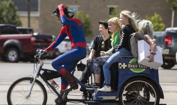 Fans attending FanX Salt Lake Comic Convention 2018 take a bike taxi at the Salt Palace Convention ...