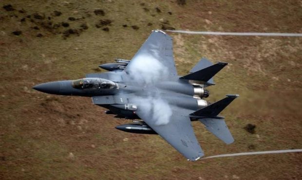 A United States Air Force F-15 fighter jet based at RAF Lakenheath speeds through the Dinas Pass, k...