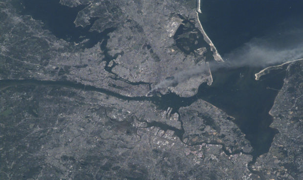 Visible from space, a smoke plume rises from the Manhattan area after two planes crashed into the t...